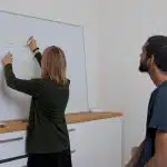 man in black crew neck t-shirt standing beside woman in black t-shirt